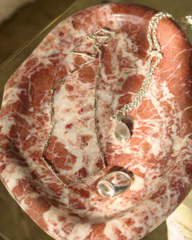 Melt Tray with silver necklaces displayed on Rosso Leggero Marble tray, 240x170x18 mm, Mined France.