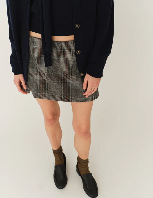 Model wearing The Garment Taylor Mini Plaid Skirt styled with a knit sweater and boots